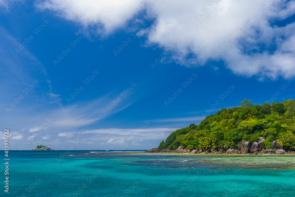 Ile Moyenne island and a small Ile Seche islet on the background in the Saint-Anne Marine National Park in Seychelles on a sunny day