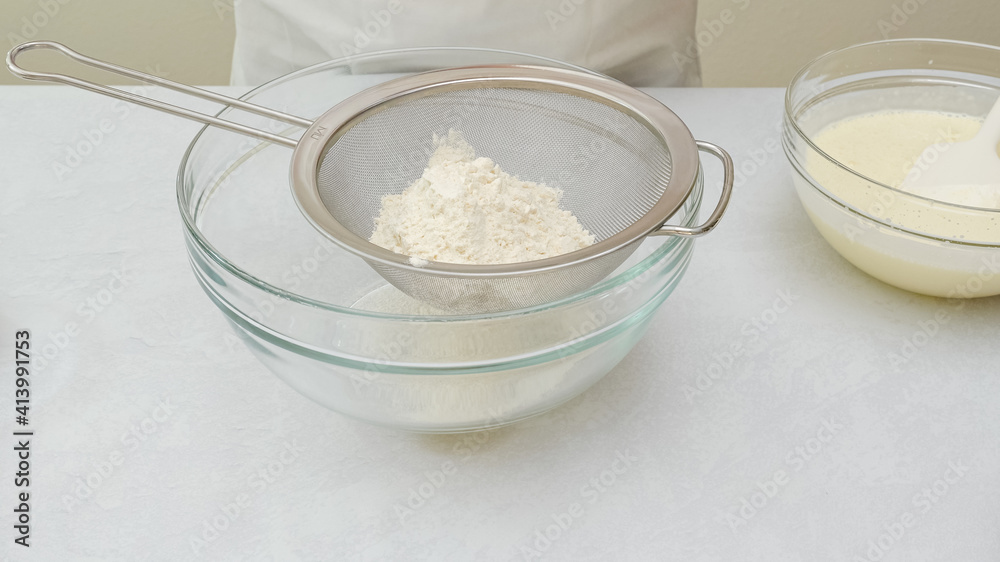 Chocolate cake step by step recipe. Mixing dry ingredients in a glass bowl Chocolate cake step by step recipe. Mixing dry ingredients in a glass bowl