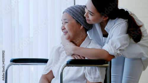 daughter encourages and comforts a mother with cancer during hospitalization.