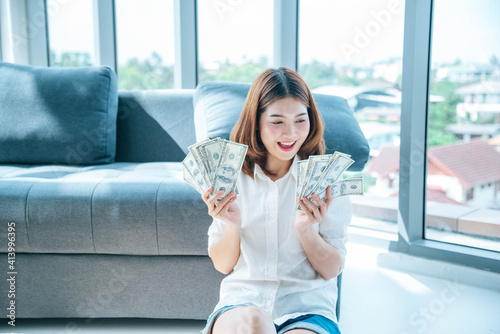 Free Download Happy young asian woman holding dollar money and throw in the air celebrate happiness dance wealth lottery money rain drop. Winner Success business woman throw cash flow Happy money smiling face - GFXLoad