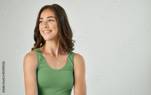 brunette in t-shirt emotions fun cropped view light background