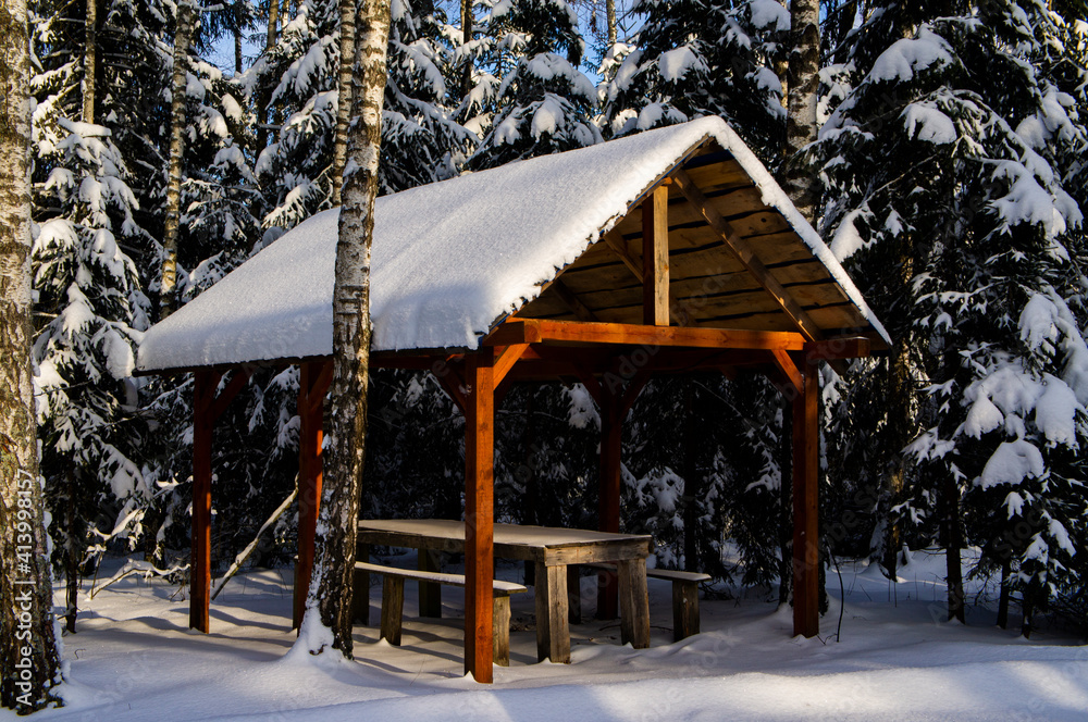 Wooden gazebo in the winter forest at the camping. 25 February 2021. Minsk, Belarus