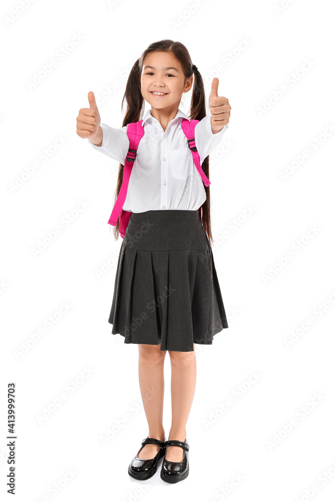 Little schoolgirl showing thumb-up gesture on white background Little schoolgirl showing thumb-up gesture on white background