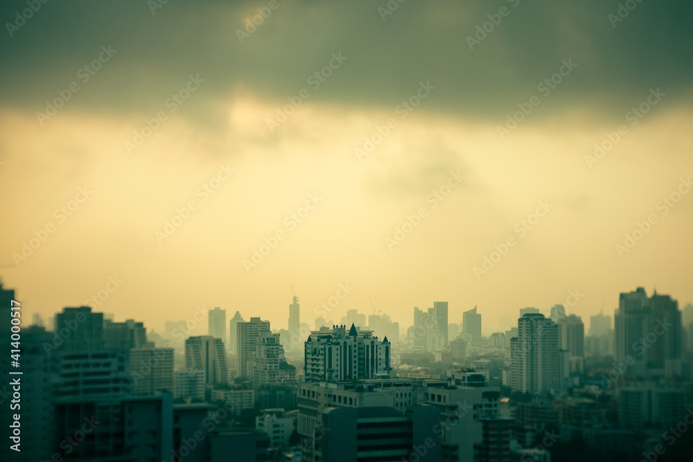 abstract blur for background, aerial cityscape of high rise buildings in poor weather morning, haze of pollution covers city, global warming concept
