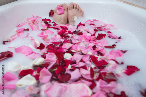 Wallpaper Mural Funny picture of a man taking a relaxing bath. Close-up of male feet in a bath with foam and rose petals Torontodigital.ca