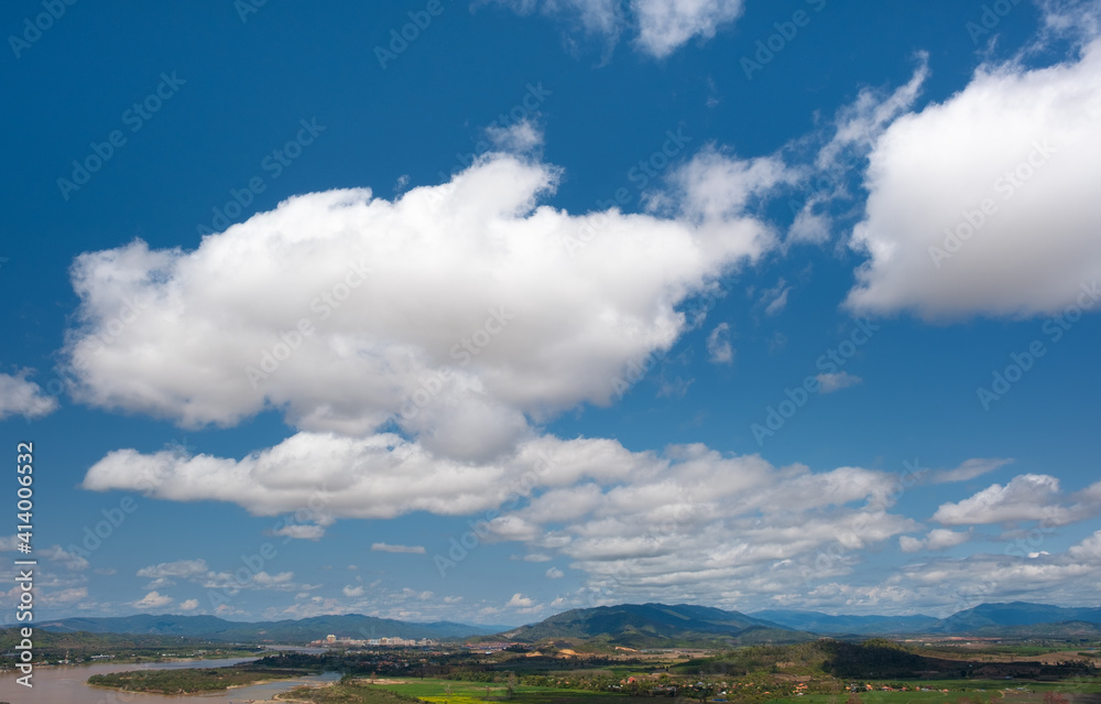 The sky has clouds and the Mekong River.sky and cloud.white clouds.Village near the river.Border river.River border Thailand and Laos. Chiang Saen,Chiang Rai. The sky has clouds and the Mekong River.sky and cloud.white clouds.Village near the river.Border river.River border Thailand and Laos. Chiang Saen,Chiang Rai.