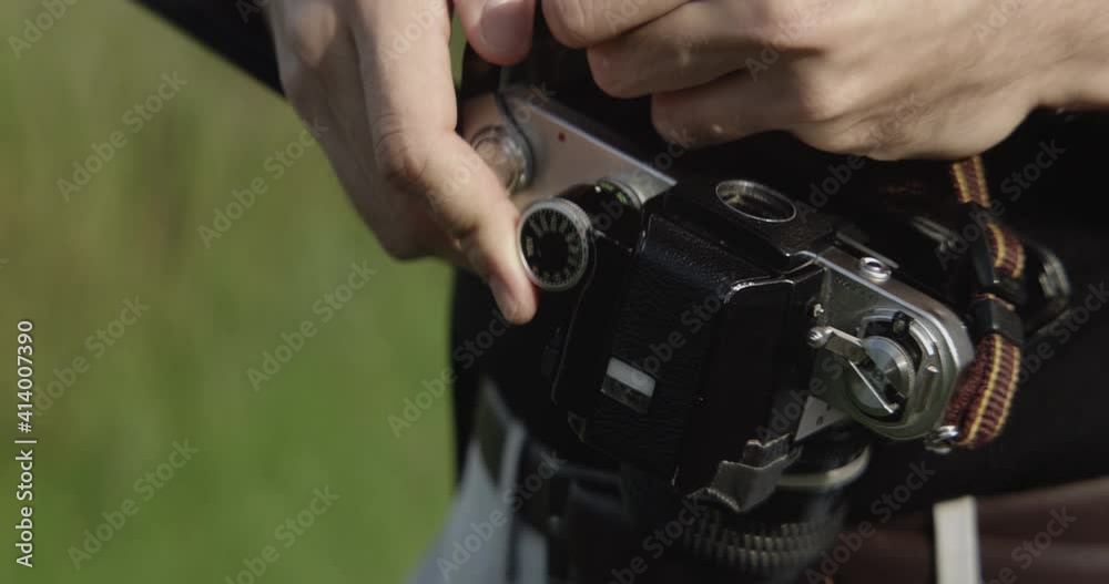 Man loading a roll of film into his camera