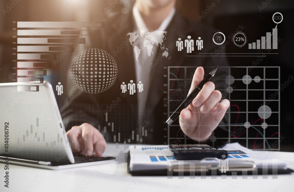 © NINENII - Business women or accountant working on laptop computer with business document, graph diagram and calculator on office table in office.