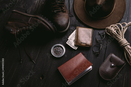 Flat lay of travel things on vintage wooden desk