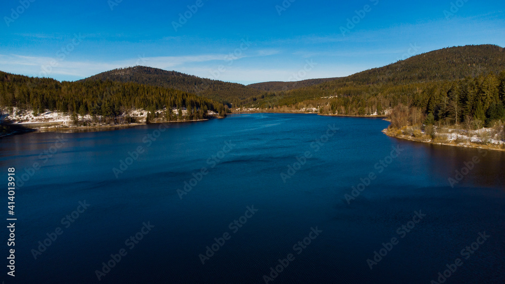 The Schwarzenbachtalsperre, a lake between mountains in the Black Forest on a sunny day. 