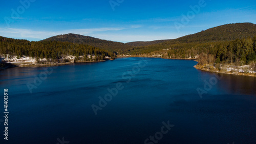 The Schwarzenbachtalsperre, a lake between mountains in the Black Forest on a sunny day. 