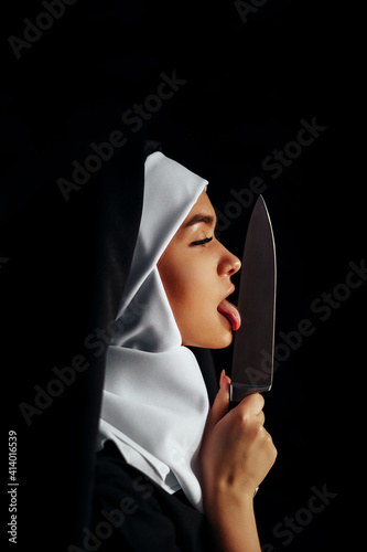 digital portrait of a nun, knife in hand, on a black background in a neon circle