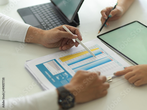 Businesspeople hands working with business paperwork and digital tablet