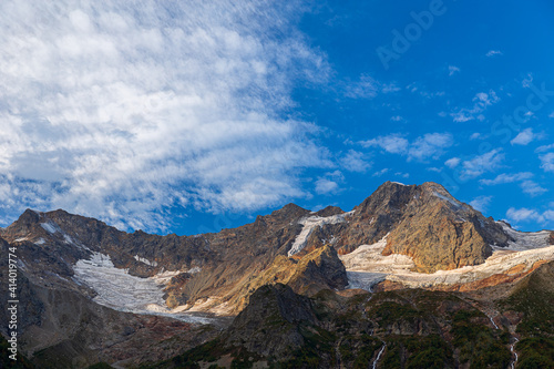 Mountain landscape at sunrise. Glaciers on the peaks of the Caucasus Mountains. National Park North Ossetia - Alania
