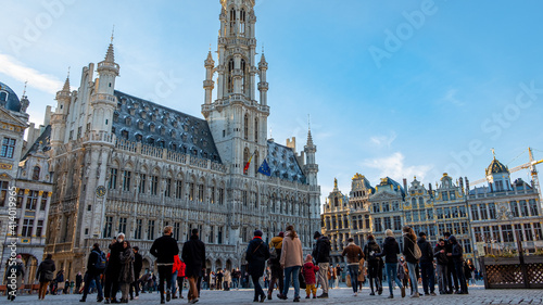 View of the Grand Place in Brussels in  winter season on a beautiful sunny day. Tourists are walking around and discovering the beautiful architecture and facade - Belgium city tour