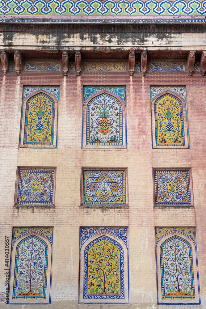 Colorful kashi-kari or faience tile mosaic pannels with floral and geometric design on ancient mughal era Wazir Khan mosque in the walled city of Lahore, Punjab, Pakistan