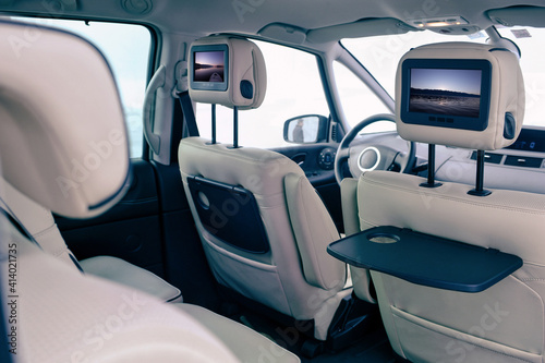 A Modern interior of the Backseats of A Car With Installes Monitors Showing Photos of the Sea
