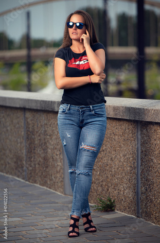 Beautiful girl portrait with black glasses and fashionable clothes in nature at summer. © Sammy photography