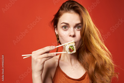 pretty woman red haired woman sushi chopsticks diet food red background