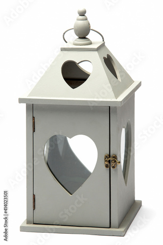 A White Wooden Lantern With Heart Shaped Windows and Holes