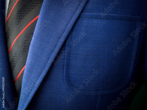 Detail closeup close-up of blue suit jacket with light blue shirt and black tie