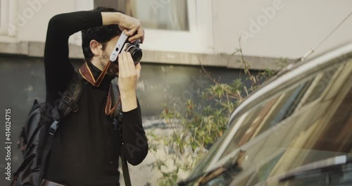 Man taking pictures of a car 