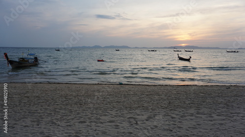 sunset and boats at the Khlong Muang Beach in Nong Thale, Krabi, Southern Thailand, March