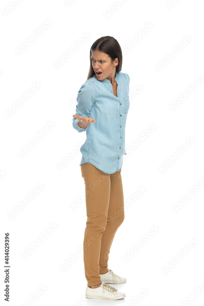 Fototapeta premium beautiful casual woman looking back over shoulder and feeling angry
