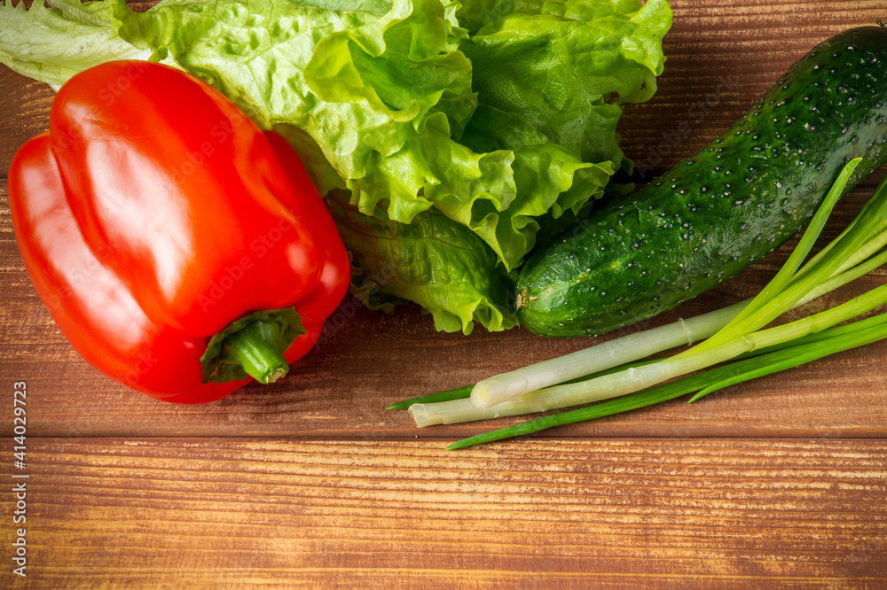 Set for making salad of fresh herbs, cucumbers and red pepper on a vintage table Set for making salad of fresh herbs, cucumbers and red pepper on a vintage table