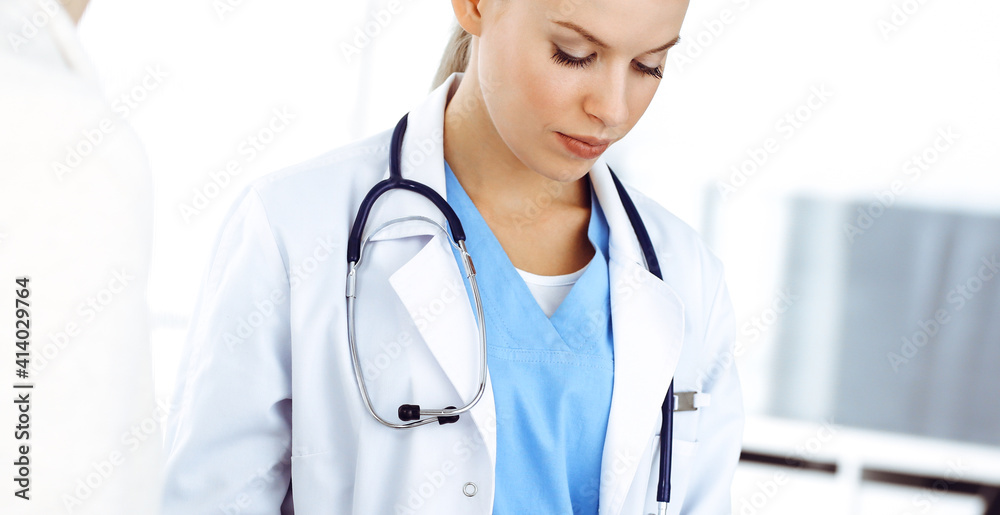 Woman - doctor consults her female patient while using clipboard and medication history record. Medicine concept Woman - doctor consults her female patient while using clipboard and medication history record. Medicine concept