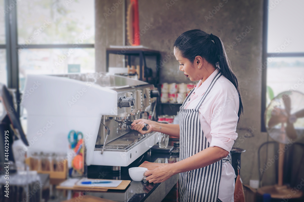 Woman cafe owner in apron looking at camera and smiling. Woman cafe owner in apron looking at camera and smiling.