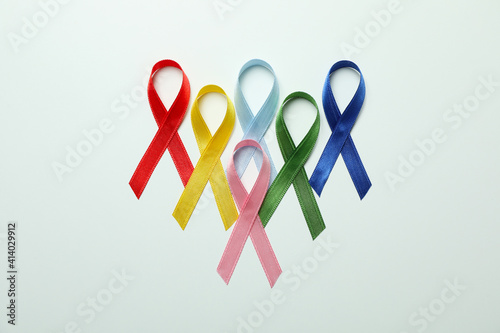 Different multi colored awareness ribbons on white background