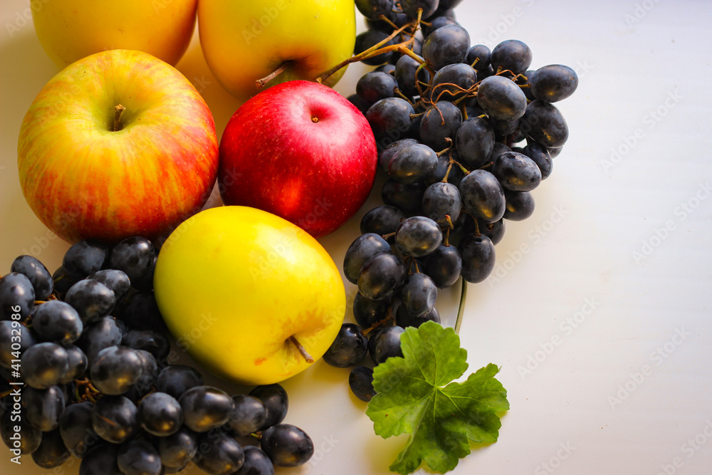 Fall fruits still life. Grapes and apples on a light background with room for copying Fall fruits still life. Grapes and apples on a light background with room for copying