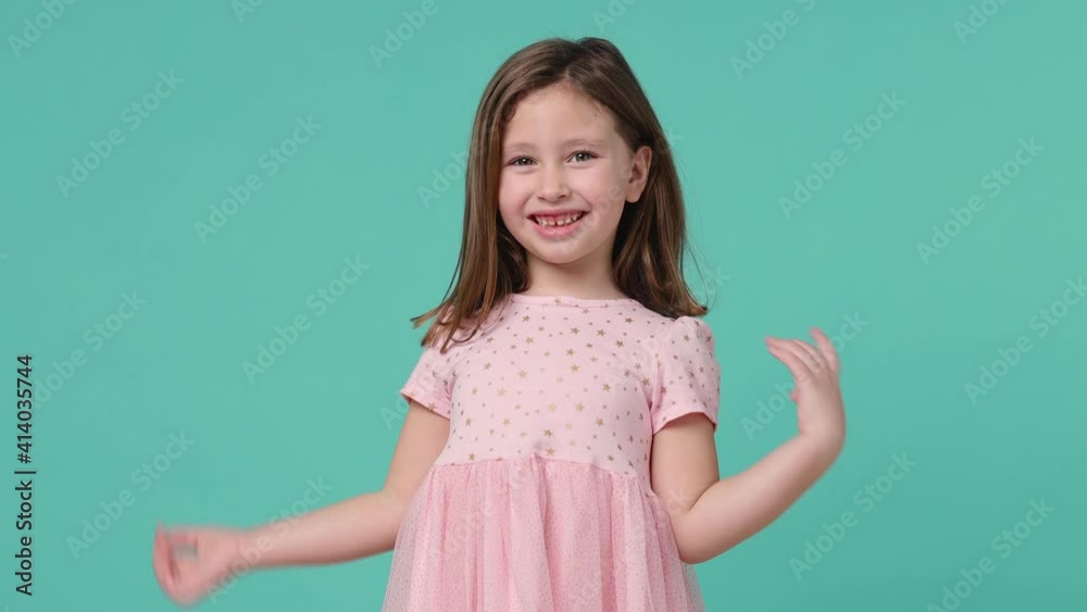 Little toothy smiling cheery cute kid girl 5-6 years old wears pink dress have fun isolated on pastel blue background child studio portrait. Mother's Day love family people childhood lifestyle concept