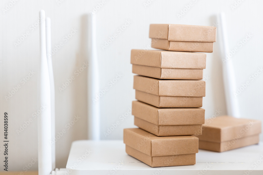 Paper cartons or parcel on internet router, Online shopping form electronic commerce that allows consumers to directly buy goods from a seller over the internet, Idea for shopping online.