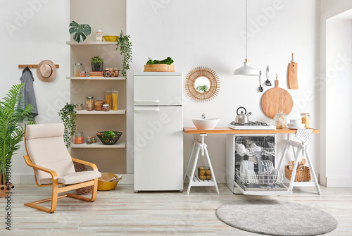 Decorative kitchen interior style, dishwasher, refrigerator, wooden bench, utensils lamp mirror accessory, bookshelf and ornament decoration with chair.