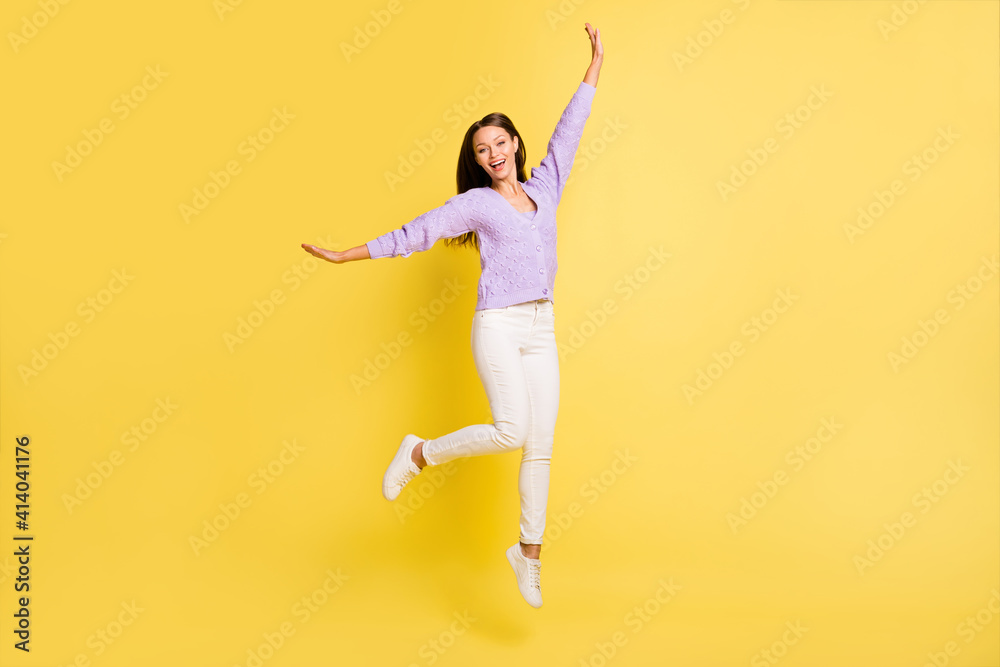Full length body size view of carefree cheerful girl jumping having fun rest party isolated over bright yellow color background
