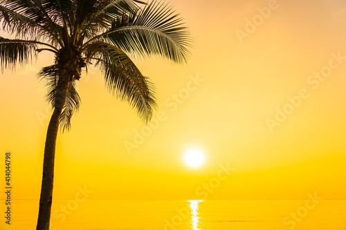 Fototapeta Naklejka Na Ścianę i Meble -  Coconut palm tree around sea beach ocean at sunset or sunrise