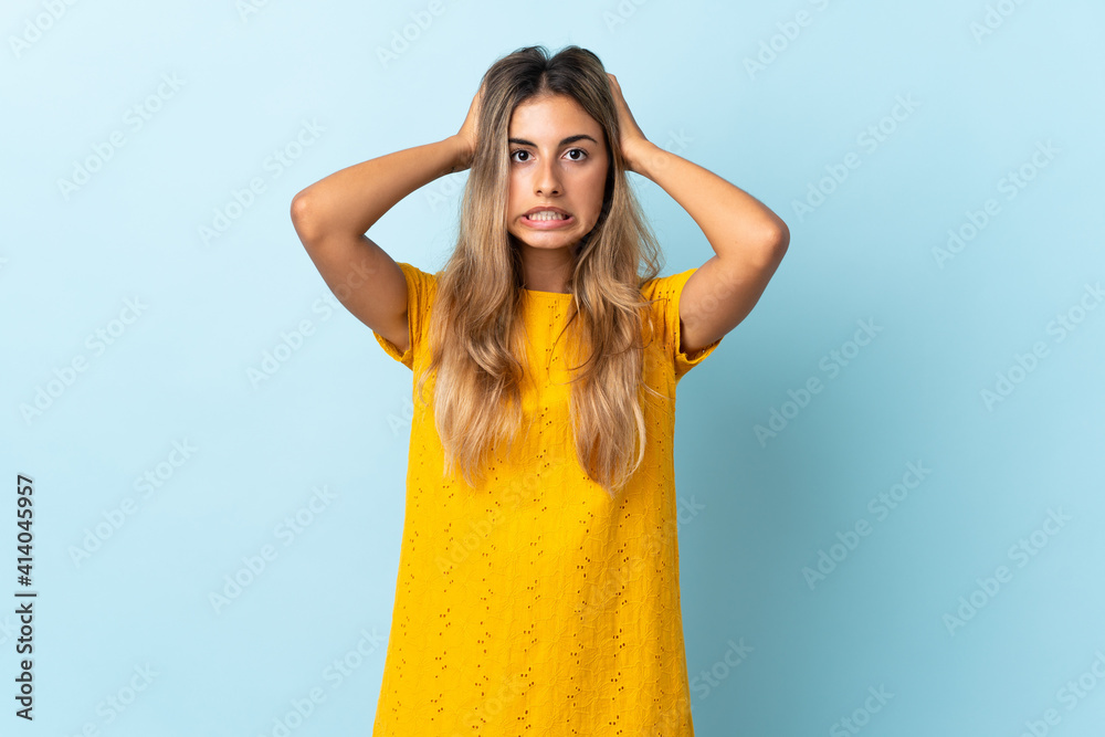 Young hispanic woman over isolated blue background doing nervous gesture Young hispanic woman over isolated blue background doing nervous gesture