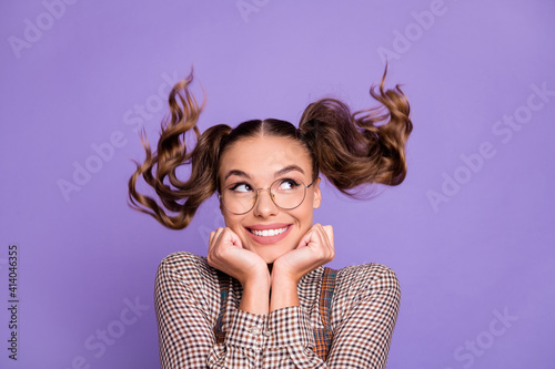 Photo of optimistic brunette girl look empty space hands chin wear spectacles brown shirt isolated on lilac color background © deagreez