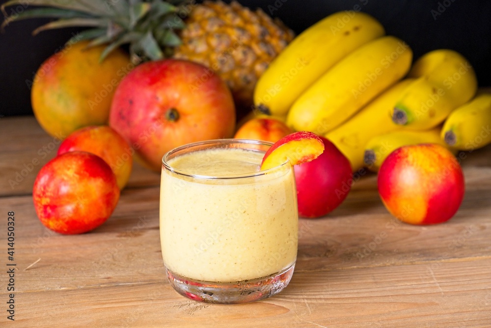 Healthy fruit smoothie in glass in front of fresh fruit Healthy fruit smoothie in glass in front of fresh fruit