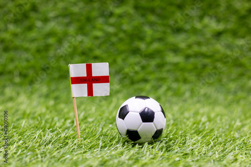 Soccer ball with England Flag on green grass background
