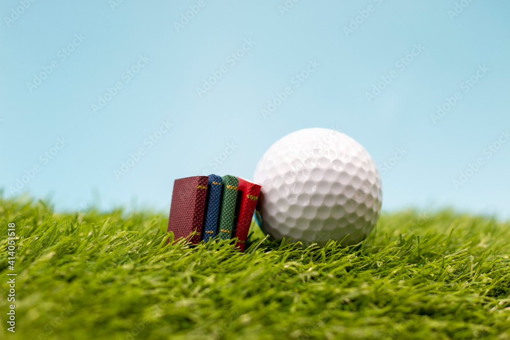 Naklejka premium Golf ball with books for rules or training academy concept
