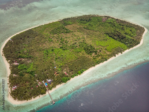 Aerial view of Kaniungan Besar Island with golden beach and a small pier, a small paradise island in Celebes sea, Kalimantan Timur. photo