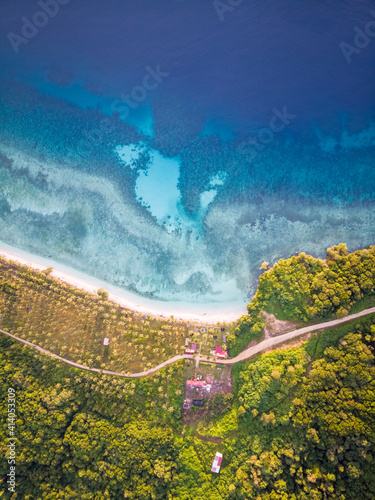 Aerial view of Lamin Guntur luxury resort with a few bungalow facing the blue water of Celebes Sea, a tropical destination island, Kalimantan Timur, Indonesia. photo