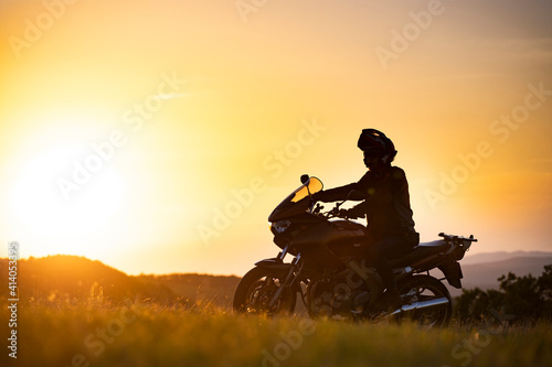 Man on his motorbike riding into sunset
