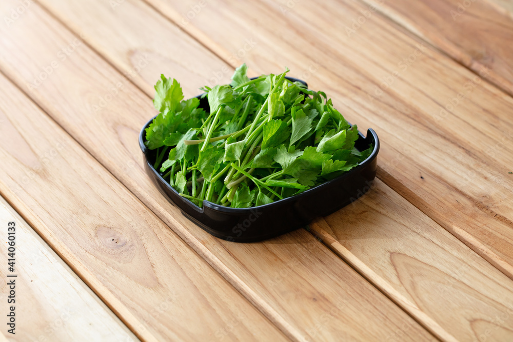 fresh raw celery sliced on square plate isolated on wooden background, shabu, hot pot ingredients fresh raw celery sliced on square plate isolated on wooden background, shabu, hot pot ingredients