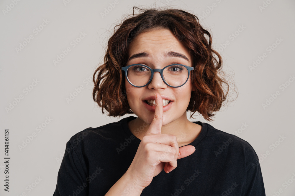 Lovely young girl showing silence gesture isolated Lovely young girl showing silence gesture isolated