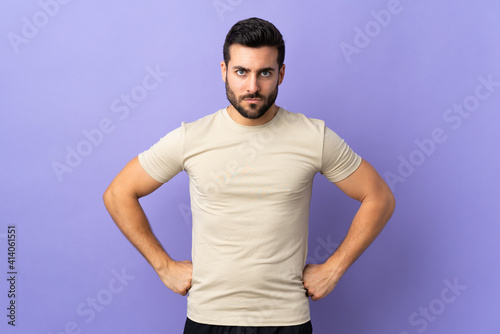 Young handsome man with beard over isolated background angry