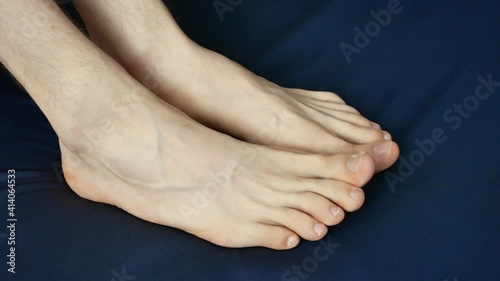 Close-up of the feet of a man wiggling his toes